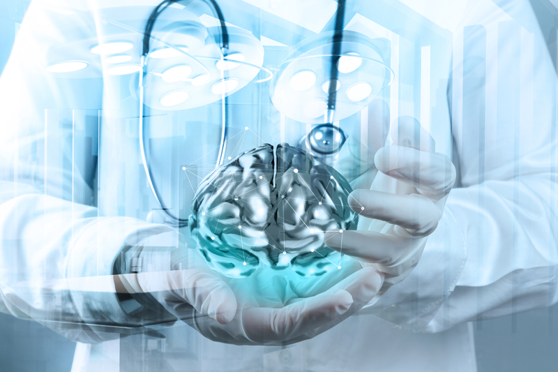 doctor holding a 3d image of a brain